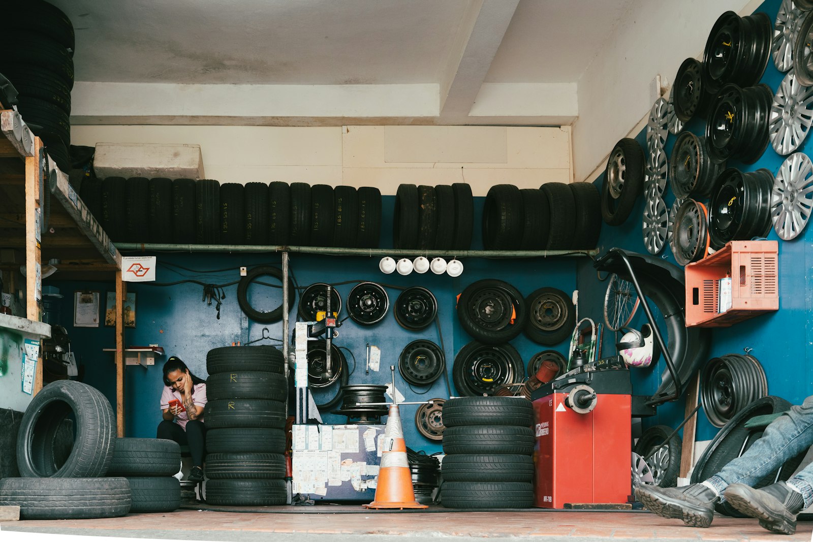 D's Tire Services shop interior with tires and wheels on shelves