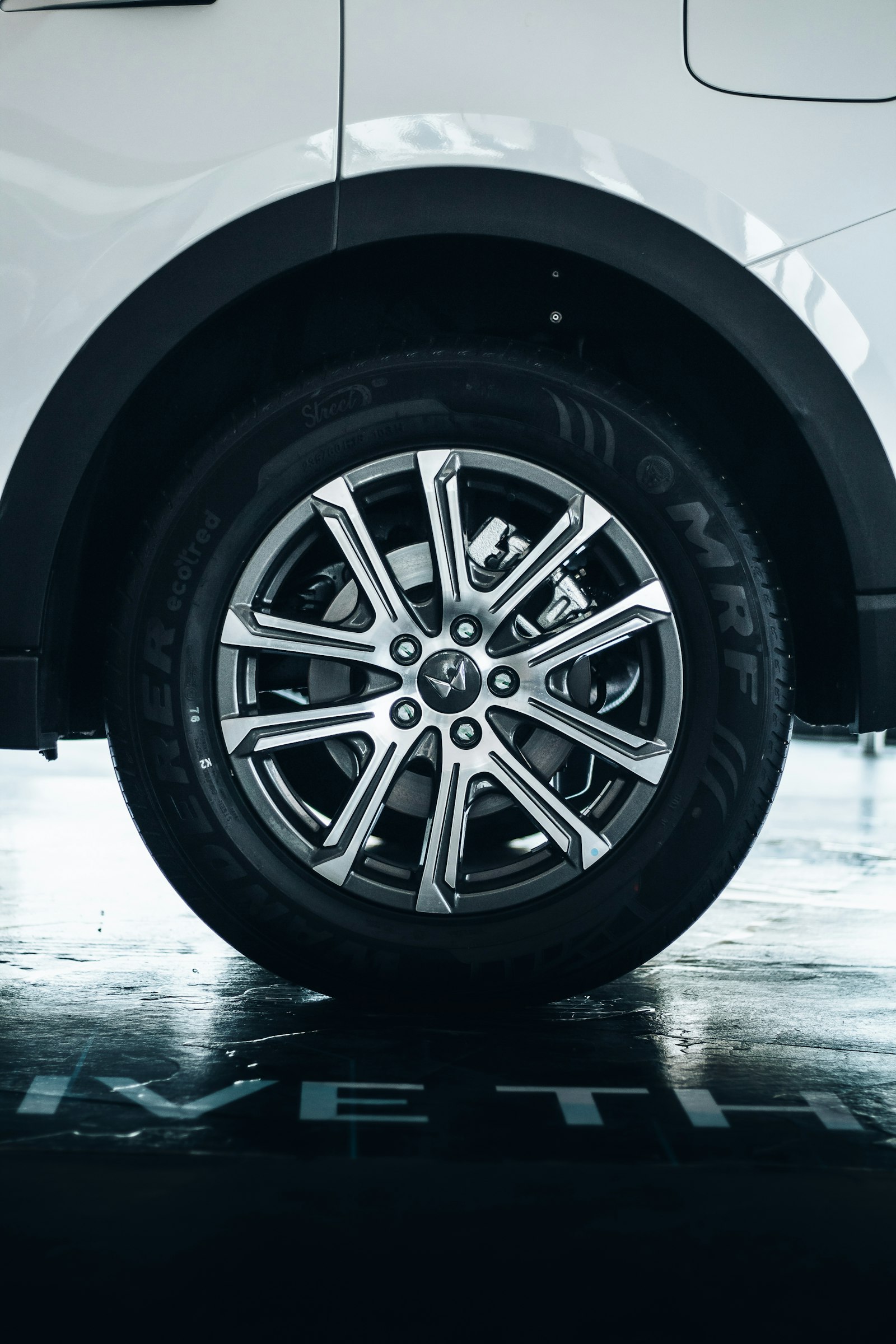 Close-up of a clean MRF tire on a white car